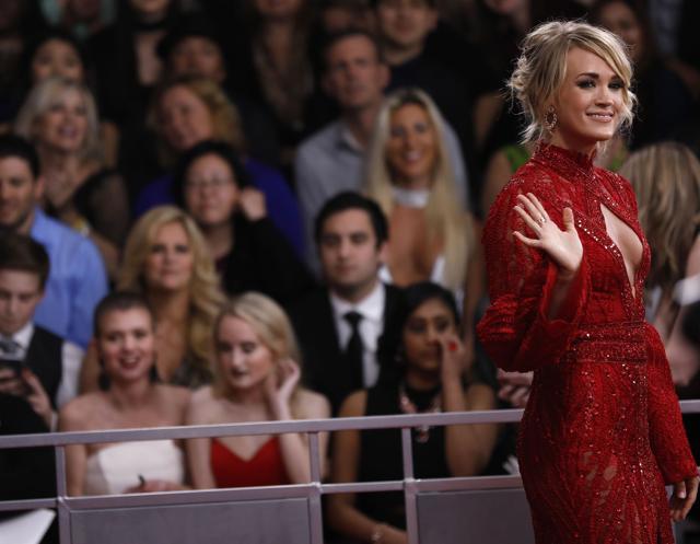 Carrie Underwood chose fiery red, with a sexy keyhole front. (REUTERS) Carrie Underwood chose fiery red, with a sexy keyhole front. (REUTERS)