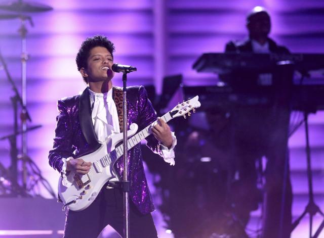 Bruno Mars performs a tribute to Prince at the 59th annual Grammy Awards on Sunday. (Matt Sayles/Invision/AP) Bruno Mars performs a tribute to Prince at the 59th annual Grammy Awards on Sunday. (Matt Sayles/Invision/AP)