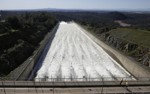 In this Feb. 11, 2017, photo, water flows down Oroville Dam's main spillway, in Oroville, California. Water began flowing over the emergency spillway on Saturday for the first time in its nearly 50-year history after heavy rainfall. (AP) In this Feb. 11, 2017, photo, water flows down Oroville Dam's main spillway, in Oroville, California. Water began flowing over the emergency spillway on Saturday for the first time in its nearly 50-year history after heavy rainfall. (AP)