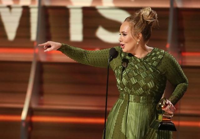 Adele accepts the Grammy for Record of the Year for Hello given to her and co-writer Greg Kurstin (not pictured) at the 59th Annual Grammy Awards in Los Angeles. Adele accepts the Grammy for Record of the Year for Hello given to her and co-writer Greg Kurstin (not pictured) at the 59th Annual Grammy Awards in Los Angeles.