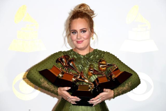 Singer Adele, winner of Album Of The Year and Best Pop Vocal Album for 25 and Song Of The Year, Record Of The Year and Best Pop Solo Performance for Hello, poses with her award trophies. (AFP) Singer Adele, winner of Album Of The Year and Best Pop Vocal Album for 25 and Song Of The Year, Record Of The Year and Best Pop Solo Performance for Hello, poses with her award trophies. (AFP)