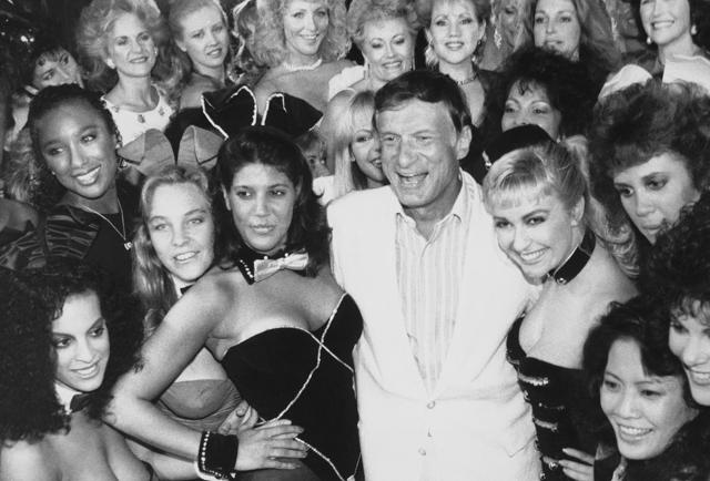 In this June 25, 1986 file photo, Playboy founder Hugh Hefner, center, poses with a group of current and former Playboy bunnies at the Playboy Club in Los Angeles, days before the club closed. (AP)