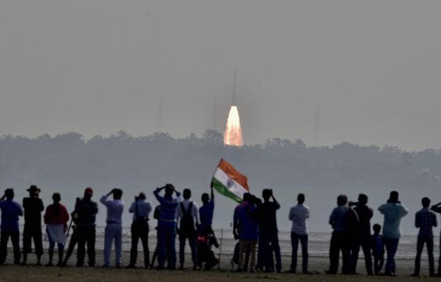People watch as a rocket takes off successfully to launch a record 104 satellites, in Sriharikota. (PTI Photo) People watch as a rocket takes off successfully to launch a record 104 satellites, in Sriharikota. (PTI Photo)