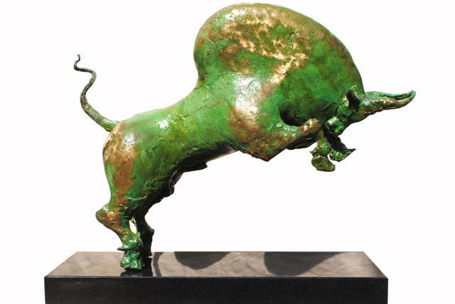 A bronze and granite sculpture of a bull with patina - the green layer on top.