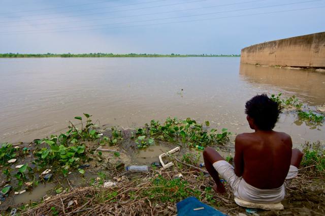 A man looks at river ganga as he sits near the garbage thrown in the river in Kanpur. (Priyanka Parashar/ Mint) A man looks at river ganga as he sits near the garbage thrown in the river in Kanpur. (Priyanka Parashar/ Mint)