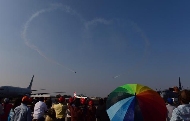Indian Air Force's (IAF) aerobatic team ‘Sarang‘ performs at the 11th biennial edition of Aero India 2017 at Yelahanka Air base in Bengaluru on Thursday. The air show will bear witness to the Defence Research and Development Organisation delivering the country’s first indigenous airborne early warning and control system (AEW&C) to the IAF in initial operational clearance configuration, bringing it a step closer to induction. (SHAILENDRA BHOJAK / PTI) Indian Air Force's (IAF) aerobatic team ‘Sarang‘ performs at the 11th biennial edition of Aero India 2017 at Yelahanka Air base in Bengaluru on Thursday. The air show will bear witness to the Defence Research and Development Organisation delivering the country’s first indigenous airborne early warning and control system (AEW&C) to the IAF in initial operational clearance configuration, bringing it a step closer to induction. (SHAILENDRA BHOJAK / PTI)