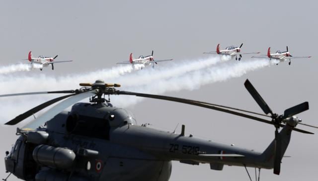 The Yakovlevs, a UK-based aerobatic team flying Russian designed Yakovlev aircrafts, fly over an Indian Air Force helicopter on the third day of Aero India 2017 at Yelahanka air base in Bangalore, India, Thursday, Feb. 16, 2017. India and Russia are nearing a joint venture to make light helicopters in India, reviving a plan announced by Russian President Vladimir Putin in 2015. (AIJAZ RAHI / AP) The Yakovlevs, a UK-based aerobatic team flying Russian designed Yakovlev aircrafts, fly over an Indian Air Force helicopter on the third day of Aero India 2017 at Yelahanka air base in Bangalore, India, Thursday, Feb. 16, 2017. India and Russia are nearing a joint venture to make light helicopters in India, reviving a plan announced by Russian President Vladimir Putin in 2015. (AIJAZ RAHI / AP)