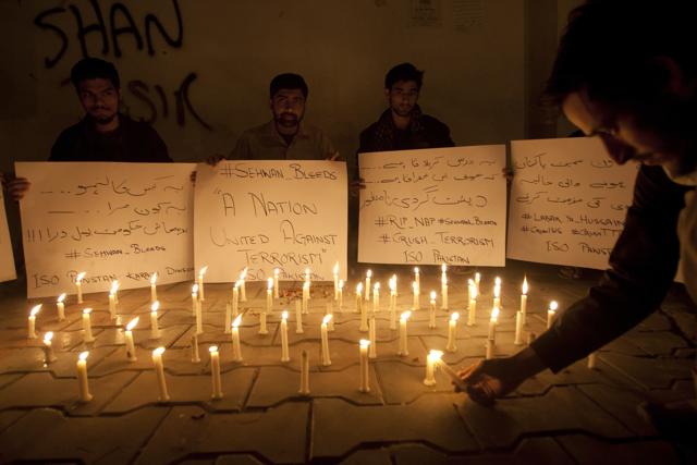 Students in Karachi light candles to condemn the attack on the Sufi shrine. (AP) Students in Karachi light candles to condemn the attack on the Sufi shrine. (AP)