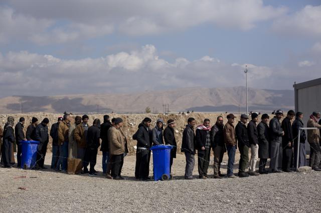Iraqis from Mosul queue for permission to pass through a checkpoint in Bartella. Hundreds of people arrive at the checkpoint every day either fleeing the violence in their home city or to visit their relatives elsewhere in Iraq. (AP) Iraqis from Mosul queue for permission to pass through a checkpoint in Bartella. Hundreds of people arrive at the checkpoint every day either fleeing the violence in their home city or to visit their relatives elsewhere in Iraq. (AP)