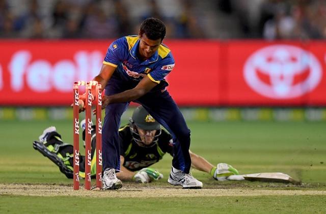 Australia's Tim Paine (behind-on ground) is run out by Nuwan Kulasekara of Sri Lanka (front). (AFP/Getty Images) Australia's Tim Paine (behind-on ground) is run out by Nuwan Kulasekara of Sri Lanka (front). (AFP/Getty Images)