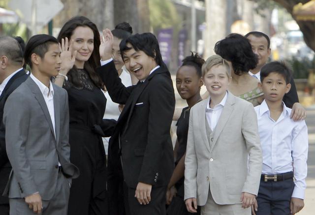 Hollywood actor Angelina Jolie, second from left, waves with her adopted children Pax, left, Maddox, center, Zahara, third from right, and Shiloh, second from right, while they wait to meet Cambodia's King Norodom Sihamoni in Siem Reap province, Cambodia. (AP) Hollywood actor Angelina Jolie, second from left, waves with her adopted children Pax, left, Maddox, center, Zahara, third from right, and Shiloh, second from right, while they wait to meet Cambodia's King Norodom Sihamoni in Siem Reap province, Cambodia. (AP)