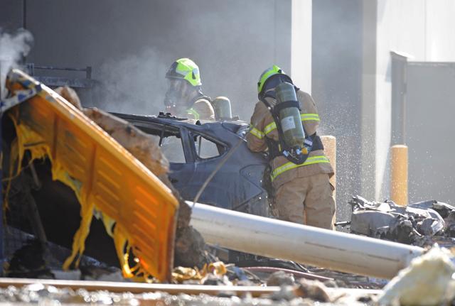 Emergency services personnel are seen at the scene of a plane crash in Essendon in Melbourne. (Reuters Photo)