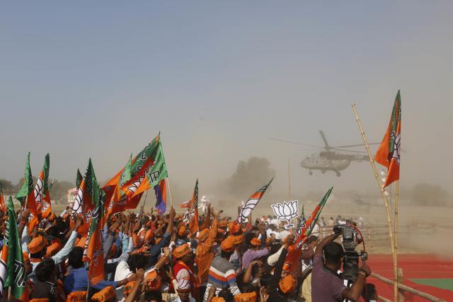 Supporters wave as Prime Minister Narendra Modi arrives in an Indian Air Force helicopter to address an election rally in Allahabad, Uttar Pradesh. (AP Photo) Supporters wave as Prime Minister Narendra Modi arrives in an Indian Air Force helicopter to address an election rally in Allahabad, Uttar Pradesh. (AP Photo)