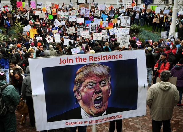 Protesters carry anti-Trump signs during a 'Not My President Day' demonstration outside City Hall in Los Angeles, California. (AFP Photo) Protesters carry anti-Trump signs during a 'Not My President Day' demonstration outside City Hall in Los Angeles, California. (AFP Photo)