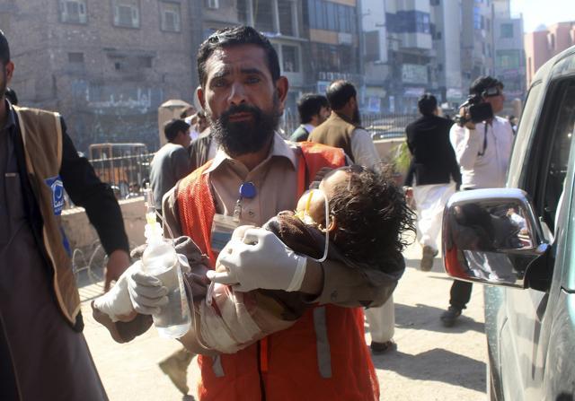 A Pakistani volunteer carries an injured child to a hospital in Peshawar on February 21, 2017 after a group of suicide bombers attacked a courthouse in the country’s northwest. Police said one bomber detonated his suicide vest at the court's main gate while police shot and killed the two other assailants. (AP) A Pakistani volunteer carries an injured child to a hospital in Peshawar on February 21, 2017 after a group of suicide bombers attacked a courthouse in the country’s northwest. Police said one bomber detonated his suicide vest at the court's main gate while police shot and killed the two other assailants. (AP)