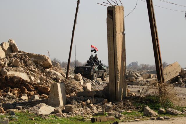 Iraqi security forces drive past a destroyed airport building after driving out Islamic State militants in Mosul on Thursday. (REUTERS) Iraqi security forces drive past a destroyed airport building after driving out Islamic State militants in Mosul on Thursday. (REUTERS)