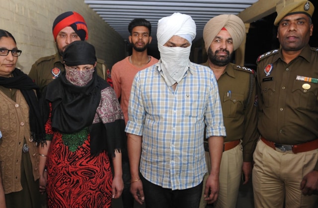 The accused in police custody (second from left) Tejinder Kaur and (third from right) Amaninder Singh. (HT Photo) The accused in police custody (second from left) Tejinder Kaur and (third from right) Amaninder Singh. (HT Photo)