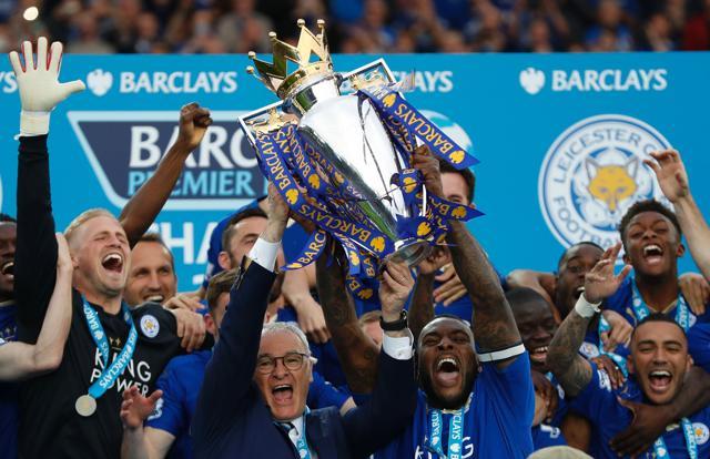 This file photo taken on May 7, 2016 shows Leicester City's Italian manager Claudio Ranieri (C) and Leicester City's English defender Wes Morgan holding up the Premier league trophy after winning the league. (AFP) This file photo taken on May 7, 2016 shows Leicester City's Italian manager Claudio Ranieri (C) and Leicester City's English defender Wes Morgan holding up the Premier league trophy after winning the league. (AFP)