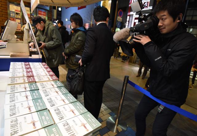 A cameraman films footage as fans of Haruki Murakami flock to a bookstore. (AFP)
