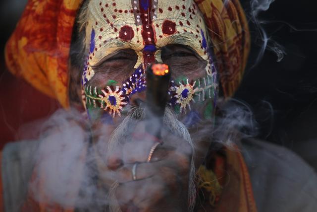 A sadhu smokes marijuana at the courtyard of the Pashupatinath temple in Kathmandu during Mahashivratri on Friday. (AP) A sadhu smokes marijuana at the courtyard of the Pashupatinath temple in Kathmandu during Mahashivratri on Friday. (AP)