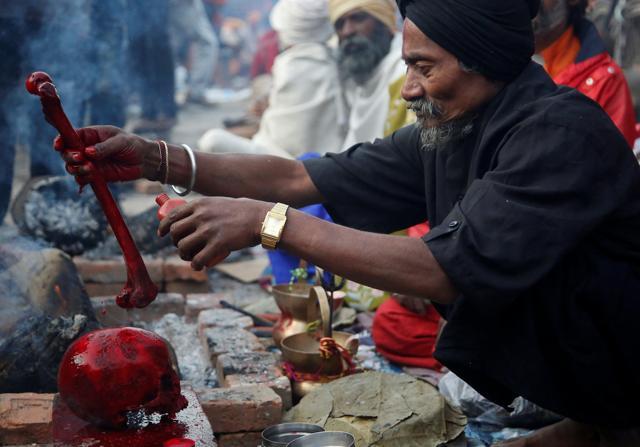 A sadhu offers prayers on a human skull at the Pashupatinath temple in Kathmandu during Mahashivratri on Friday. (REUTERS) A sadhu offers prayers on a human skull at the Pashupatinath temple in Kathmandu during Mahashivratri on Friday. (REUTERS)