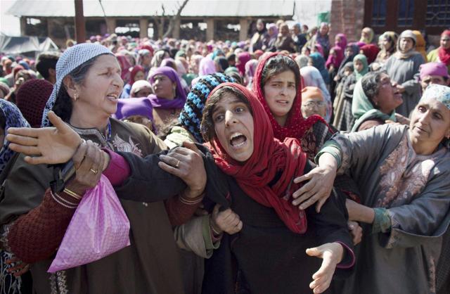 Relatives mourn the death of Ghulam Mohi-ud-din Rather during his funeral in Panjpora village on Friday. (PTI)