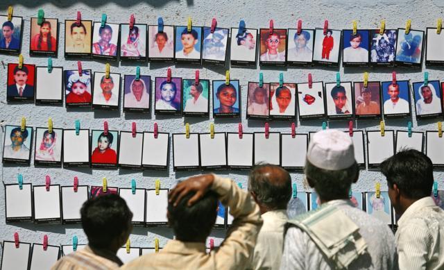 Survivors look at the pictures of the Godhra riots victims at a photo-exhibition held to commemorate its 10th anniversary in Ahmedabad, February 27, 2012. (REUTERS) Survivors look at the pictures of the Godhra riots victims at a photo-exhibition held to commemorate its 10th anniversary in Ahmedabad, February 27, 2012. (REUTERS)