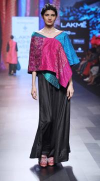 Hand-spun and printed textiles were used to create this asymmetric two-tone poncho. Hand-spun and printed textiles were used to create this asymmetric two-tone poncho.