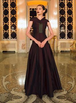 This burgundy-coloured gown, with a hand-embroidered bodice and flared bottom, is made from the outer bark of palm trees from South India. This burgundy-coloured gown, with a hand-embroidered bodice and flared bottom, is made from the outer bark of palm trees from South India.