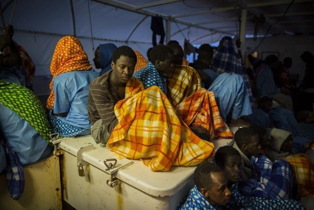 Refugees and migrants rest after being rescued off the Libyan coast. (AP Photo) Refugees and migrants rest after being rescued off the Libyan coast. (AP Photo)