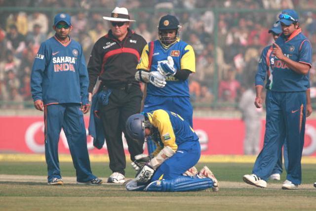Sri Lanka’s Tillakaratne Dilshan grimaces in pain (sitting) after he was hit by Ashish Nehra’s delivery during the final ODI against India at Feroz Shah Kotla stadium in New Delhi on December 27, 2009. The match was abandoned after 23 overs due to an unfit pitch. Delhi was barred from hosting any international match for a year by the International Cricket Council. (Getty Images) Sri Lanka’s Tillakaratne Dilshan grimaces in pain (sitting) after he was hit by Ashish Nehra’s delivery during the final ODI against India at Feroz Shah Kotla stadium in New Delhi on December 27, 2009. The match was abandoned after 23 overs due to an unfit pitch. Delhi was barred from hosting any international match for a year by the International Cricket Council. (Getty Images)
