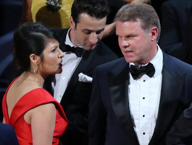 Brian Cullinan (R) and Martha Ruiz (L) of PricewaterhouseCoopers confer on stage after the Best Picture was mistakenly awarded to La La Land instead of Moonlight. Cullinan gave presenters Warren Beatty and Faye Dunaway the wrong envelope for the Best Picture Award, accounting firm PricewaterhouseCoopers said in a statement. (REUTERS) Brian Cullinan (R) and Martha Ruiz (L) of PricewaterhouseCoopers confer on stage after the Best Picture was mistakenly awarded to La La Land instead of Moonlight. Cullinan gave presenters Warren Beatty and Faye Dunaway the wrong envelope for the Best Picture Award, accounting firm PricewaterhouseCoopers said in a statement. (REUTERS)