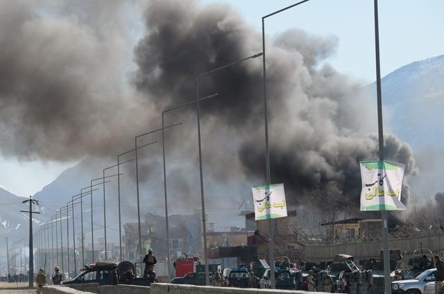 Smoke rises from an Afghan police district headquarters building after the suicide car bombing in Kabul. (AFP)