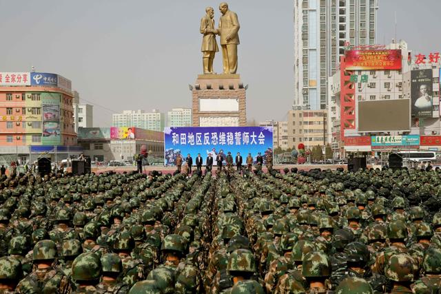 Chinese military police attend an anti-terrorist oath-taking rally in Hetian in China's Xinjiang Uighur Autonomous Region on Monday. (AFP) Chinese military police attend an anti-terrorist oath-taking rally in Hetian in China's Xinjiang Uighur Autonomous Region on Monday. (AFP)