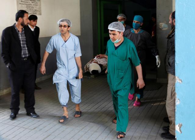 Hospital workers carry an injured Afghan security force personnel after the attacks in Kabul. (REUTERS)