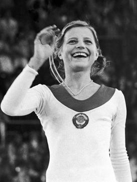 FILE - In this Aug. 31, 1972, file photo, Olga Korbut, USSR, holds up her gold medal in the gymnastics individual event at the summer Olympics in Munich. (AP)