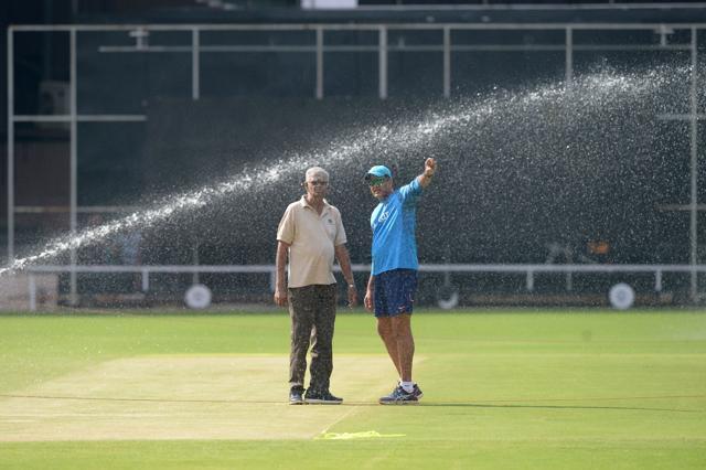Anil Kumble speaks to a groundsman at the M. Chinnaswamy Stadium in Bangalore on Wednesday. (AFP)