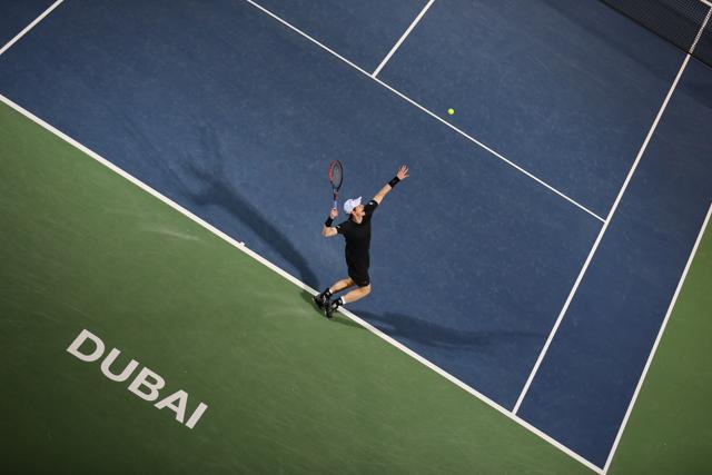 Andy Murray serves to France's Lucas Pouille in Dubai on Friday. (AFP) Andy Murray serves to France's Lucas Pouille in Dubai on Friday. (AFP)
