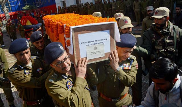 Senior officers of Jammu and Kashmir Police carry the body of constable Manzoor Ahmad who was killed in an encounter in Tral. (PTI) Senior officers of Jammu and Kashmir Police carry the body of constable Manzoor Ahmad who was killed in an encounter in Tral. (PTI)