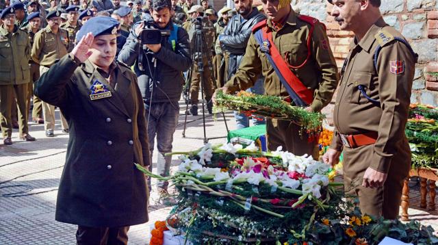 A J&K Police officer pays tribute to constable Manzoor Ahmad who was killed in an encounter in Tral. (PTI) A J&K Police officer pays tribute to constable Manzoor Ahmad who was killed in an encounter in Tral. (PTI)