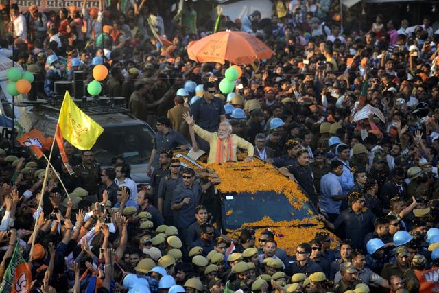 Prime Minister Narendra Modi waves during his second road show in Varanasi on Sunday. (Arun Sharma/HT PHOTO)