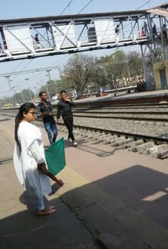 A woman station master gets ready to flag off a train during a trial run at the Daltoganj railway station. (Vishal Sharma/HT Photo) A woman station master gets ready to flag off a train during a trial run at the Daltoganj railway station. (Vishal Sharma/HT Photo)