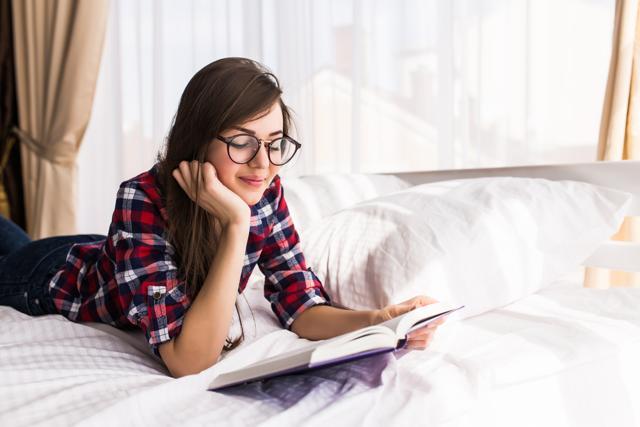 A tracking device may register reading in bed as sleep. (Shutterstock)