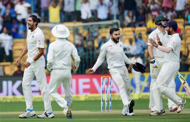 Ishant Sharma and Virat Kohli celebrate with teammates the wicket of Australia's Mitchell Marsh on Saunday in Bangalore. (PTI) Ishant Sharma and Virat Kohli celebrate with teammates the wicket of Australia's Mitchell Marsh on Saunday in Bangalore. (PTI)