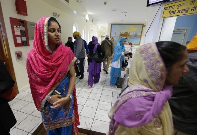 Satwinder Kaur, left, watches as people arrive for Sunday services at the Gurudwara Singh Sabha of Washington, a Sikh temple in Renton, Washington. (AP Photo) Satwinder Kaur, left, watches as people arrive for Sunday services at the Gurudwara Singh Sabha of Washington, a Sikh temple in Renton, Washington. (AP Photo)