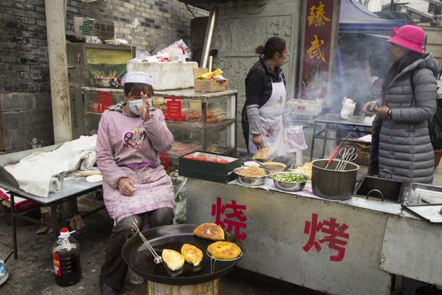 Chinese women preparing street food for sale in Songpan, Sichuan. (Shutterstock) Chinese women preparing street food for sale in Songpan, Sichuan. (Shutterstock)