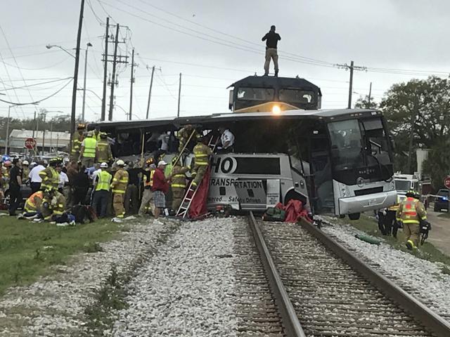 Biloxi firefighters assist injured passengers after their charter bus collided with a train in Biloxi, Miss., Tuesday, March 7, 2017. (AP) Biloxi firefighters assist injured passengers after their charter bus collided with a train in Biloxi, Miss., Tuesday, March 7, 2017. (AP)