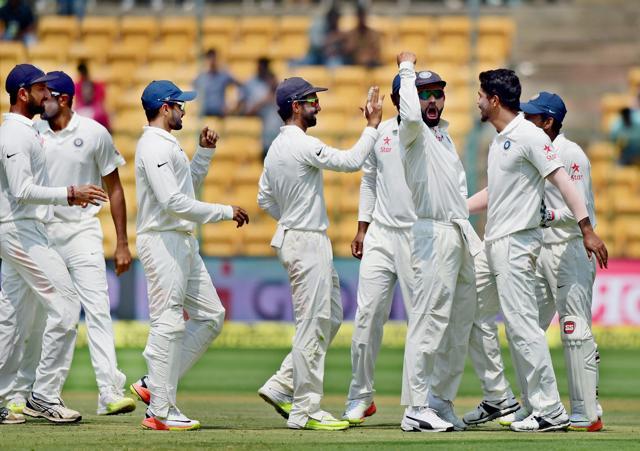 Indian players celebrate after Umesh Yadav took the wicket of Steve Smith in Bangalore on Tuesday. (PTI) Indian players celebrate after Umesh Yadav took the wicket of Steve Smith in Bangalore on Tuesday. (PTI)