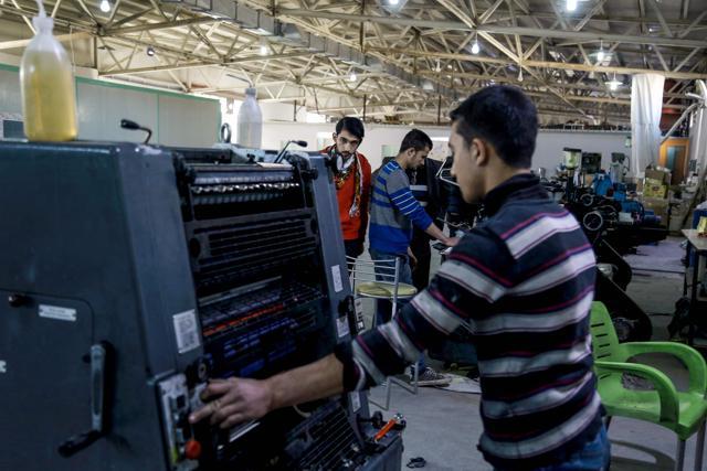 Workers oversee the printing of books at a printing company in Kurdish-majority Qamishli in northeast Syria. (AFP File Photo) Workers oversee the printing of books at a printing company in Kurdish-majority Qamishli in northeast Syria. (AFP File Photo)