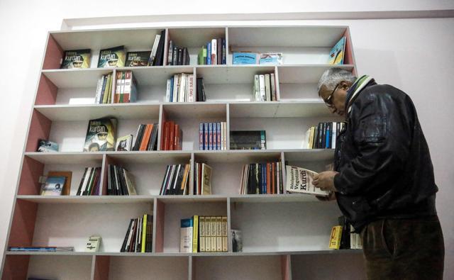 A Kurdish man reads a book at a library in Kurdish-majority Qamishli in northeast Syria. (AFP File Photo) A Kurdish man reads a book at a library in Kurdish-majority Qamishli in northeast Syria. (AFP File Photo)